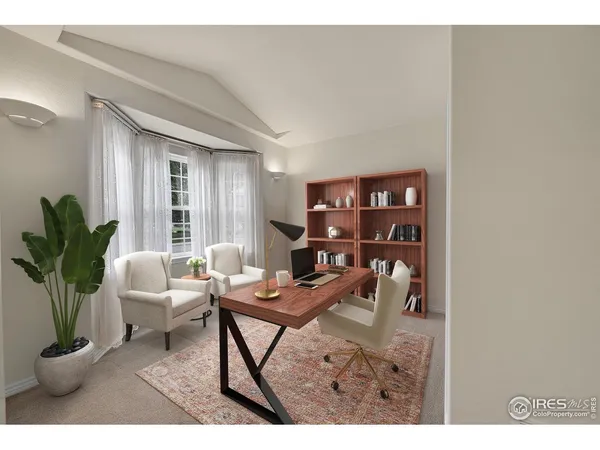 a living room with furniture a bookshelf and a potted plant