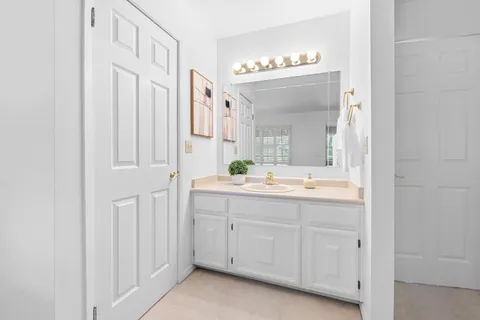 a bathroom with a double vanity sink and a mirror