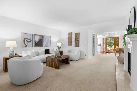 a living room with furniture a large window and a flat screen tv