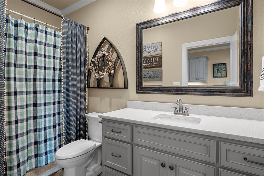14690 Chapel Road Lorena, TX 76655 - Photo 26 of 40 a bathroom with a toilet sink and mirror