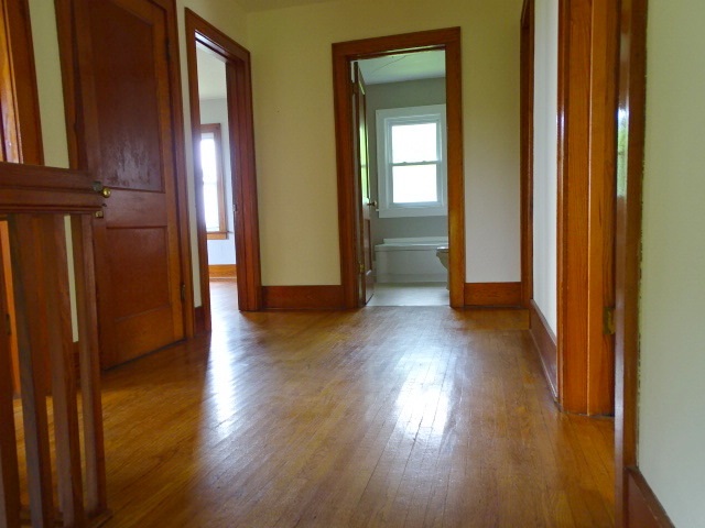 12246 North Bluff Road Baileyville, IL 61007 - Photo 18 of 37 an empty room with wooden floor and windows