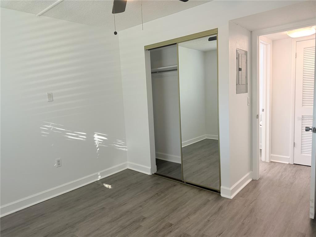 1524 Lakeview Road, Unit 305 Clearwater, FL 33756 - Photo 12 of 18 an empty room with wooden floor and closet