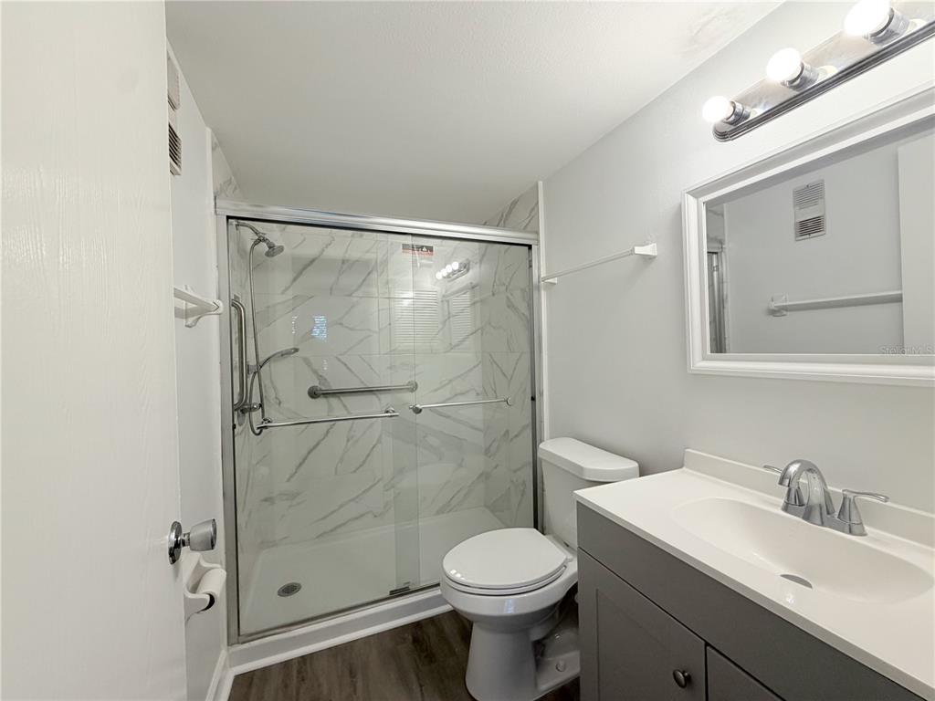 1524 Lakeview Road, Unit 305 Clearwater, FL 33756 - Photo 15 of 18 a bathroom with a shower sink vanity and toilet
