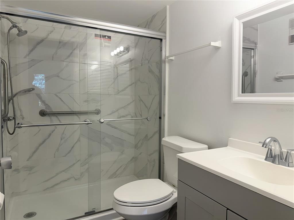 1524 Lakeview Road, Unit 305 Clearwater, FL 33756 - Photo 16 of 18 a bathroom with a sink toilet and shower