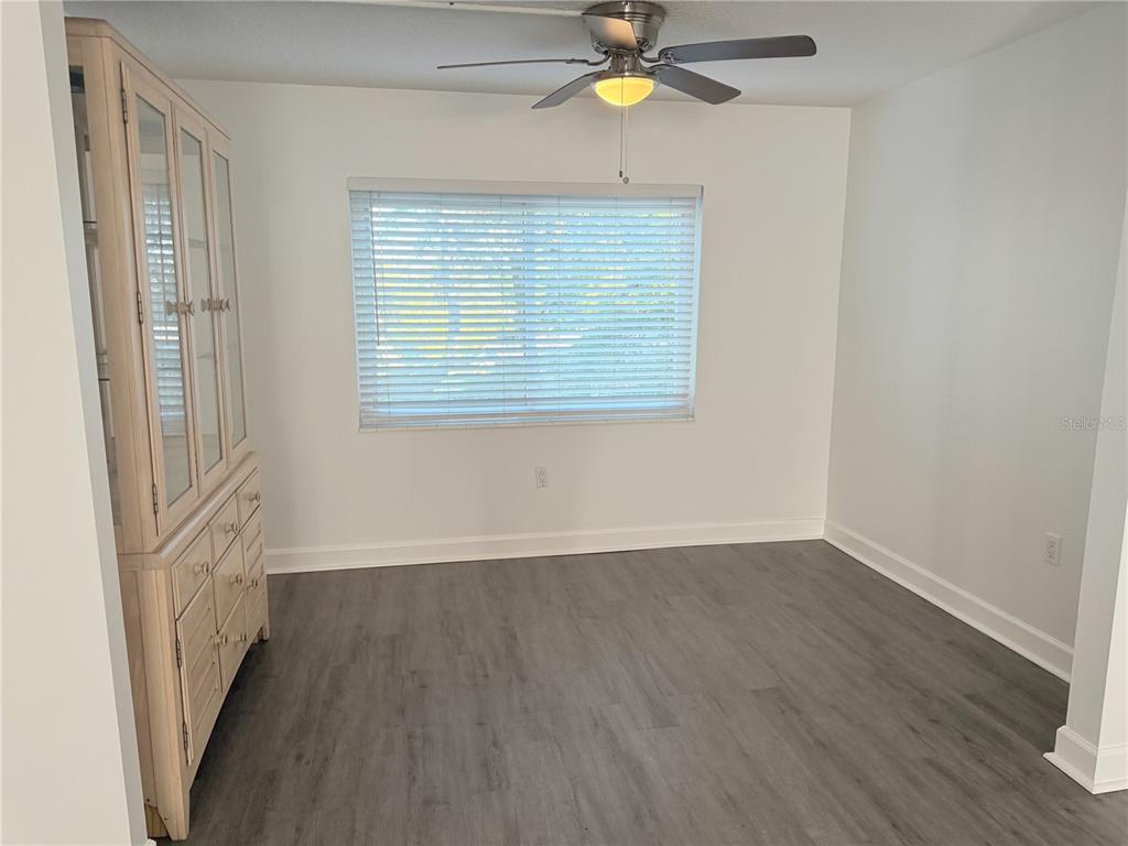 1524 Lakeview Road, Unit 305 Clearwater, FL 33756 - Photo 7 of 18 a view of an empty room with a window and wooden floor