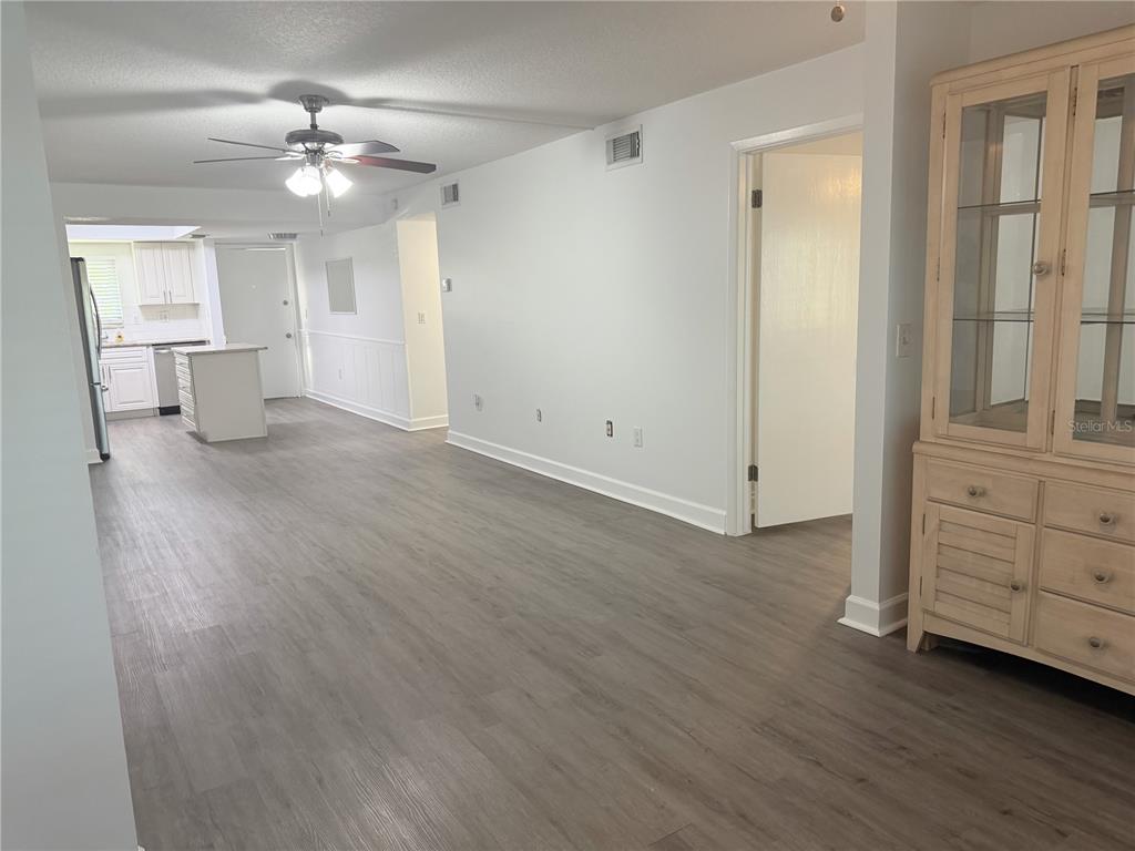 1524 Lakeview Road, Unit 305 Clearwater, FL 33756 - Photo 9 of 18 an empty room with wooden floor cabinet and windows