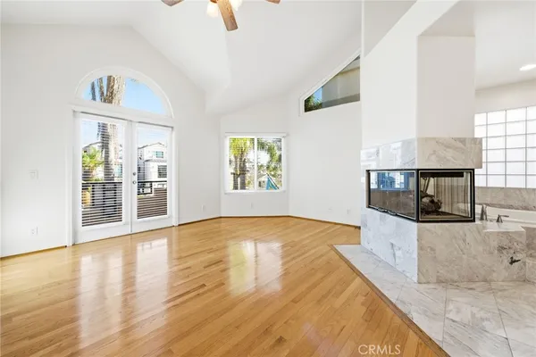 a view of a kitchen with wooden floor and a fireplace