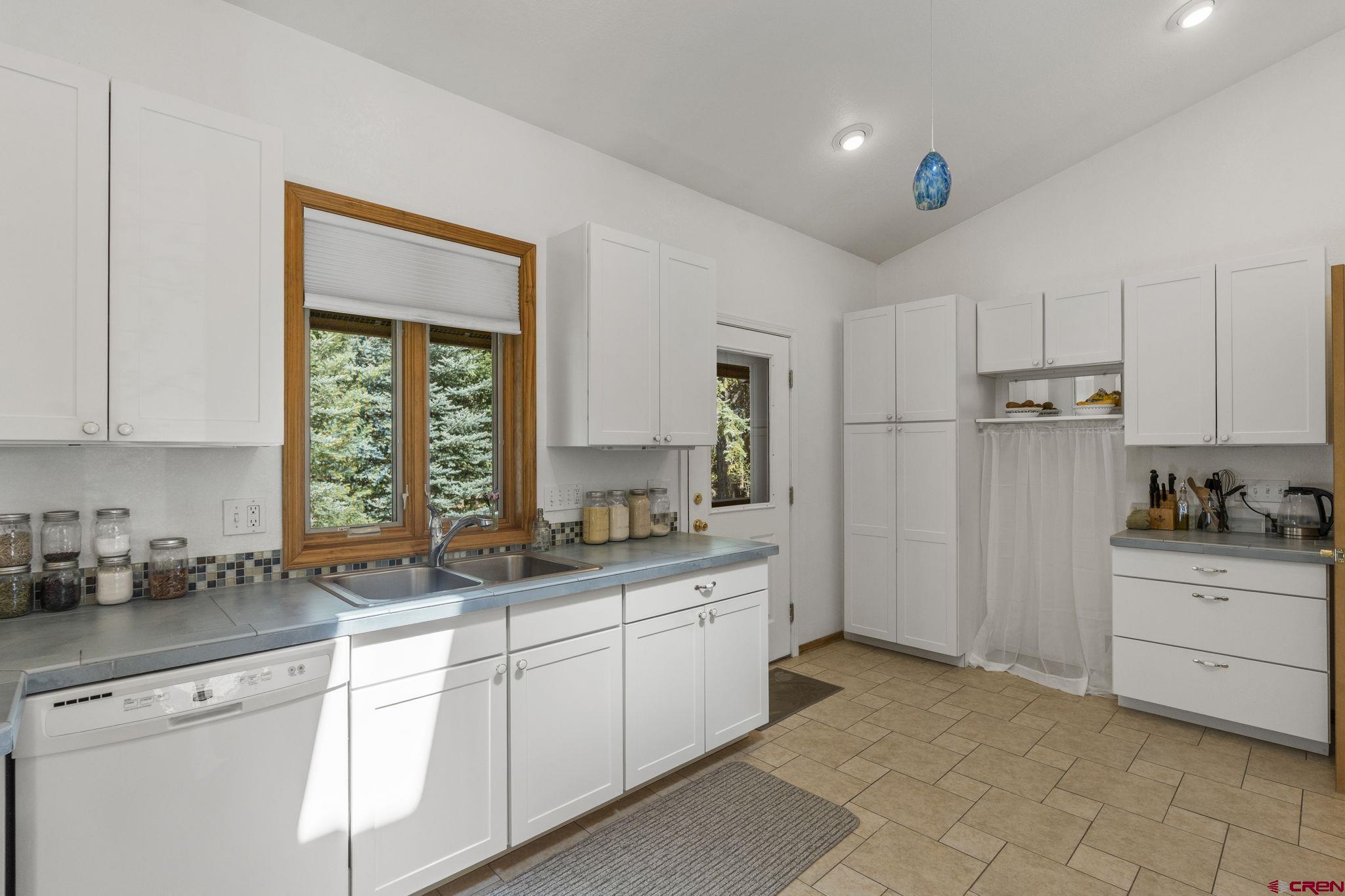 37 Verde Lane Durango, CO 81301 - Photo 36 of 45 a kitchen with white cabinets and white appliances