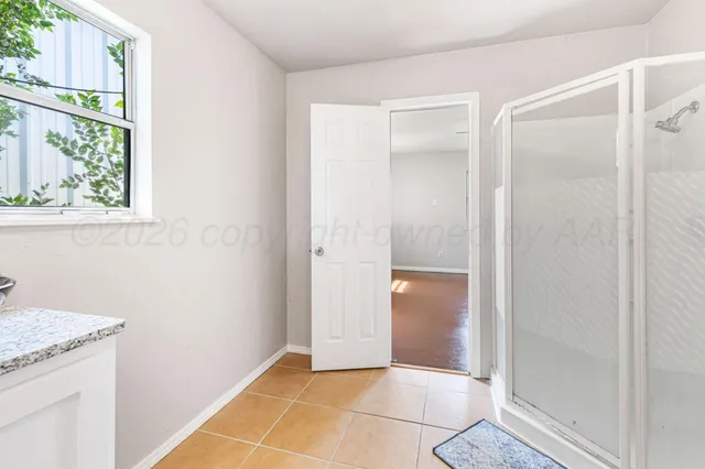 a view of an empty room with a window