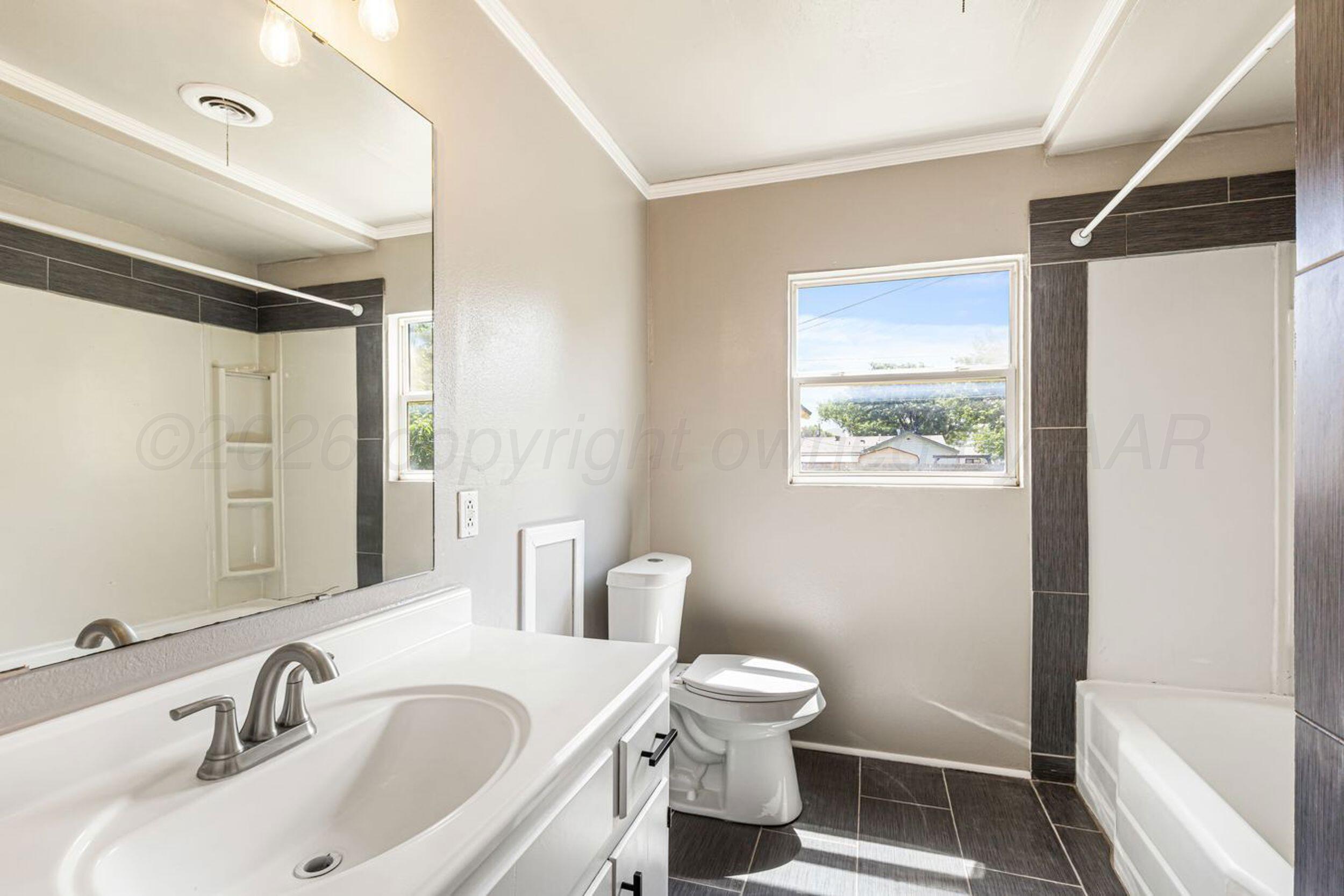 2905 South Roosevelt Street Amarillo, TX 79103 - Photo 17 of 21 a bathroom with a sink toilet and shower