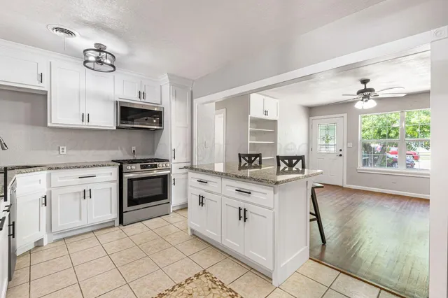 a kitchen with stainless steel appliances a stove sink and microwave