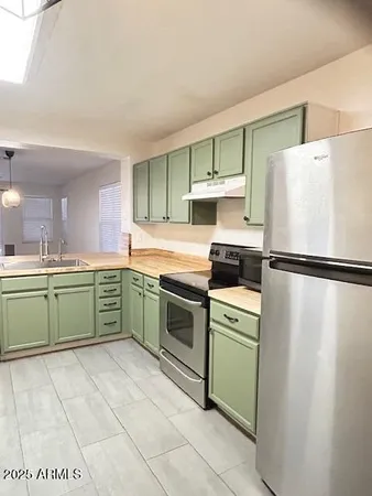 a kitchen with a refrigerator and a sink