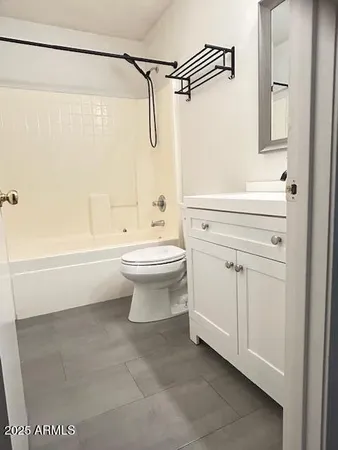 a bathroom with a white toilet and a shower