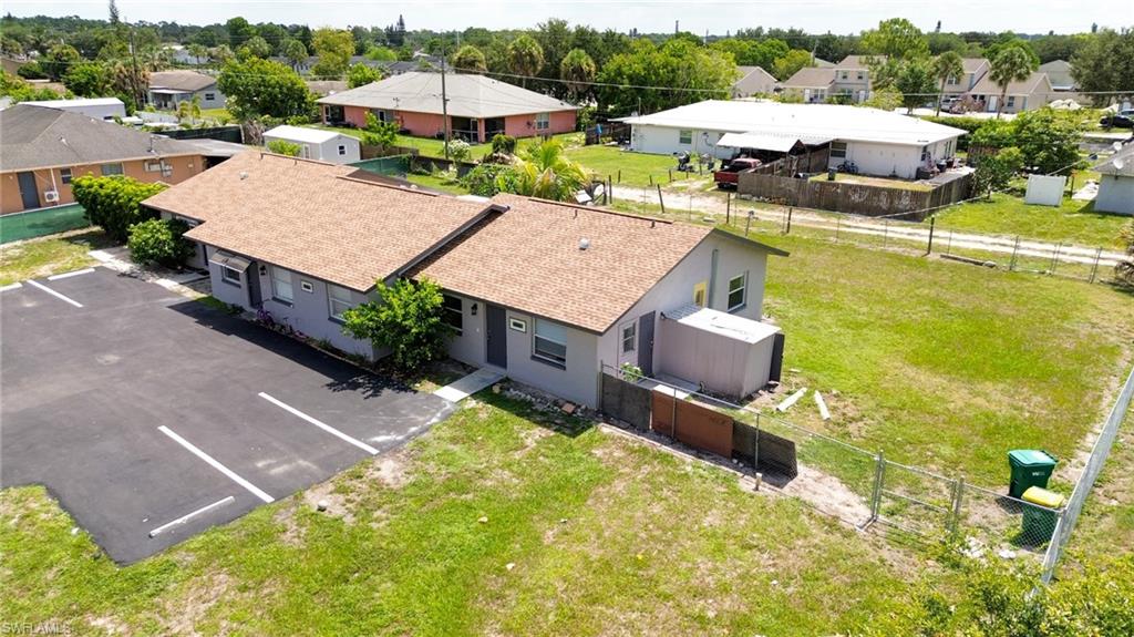 1940 48th Street Southwest Naples, FL 34116 - Photo 8 of 33 Two single-story structures with gray exteriors and brown shingle roofs