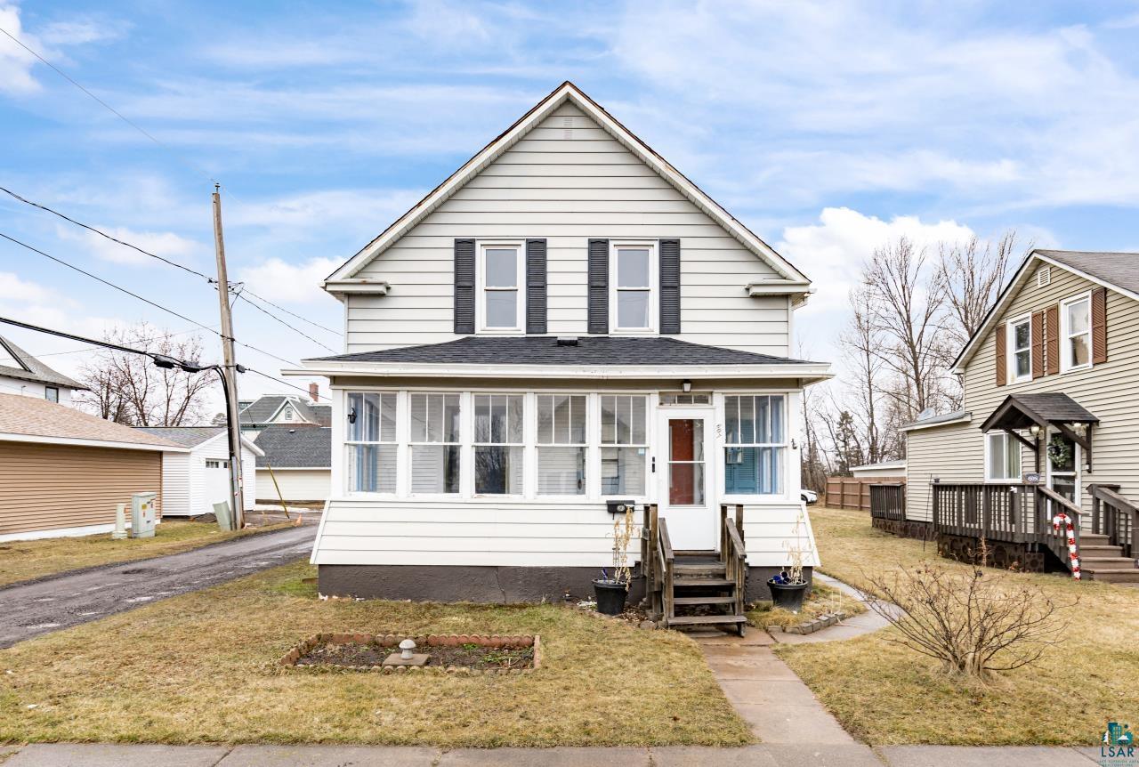 607 3rd Avenue East Superior, WI 54880 - Photo 1 of 41 View of front facade featuring a front yard, entry steps, a sunroom, and a shingled roof