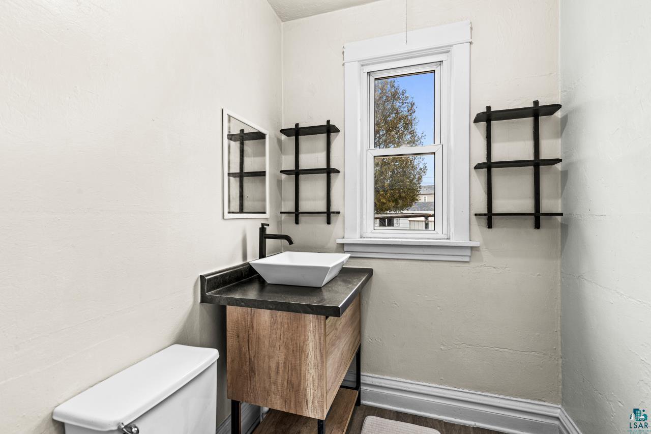 607 3rd Avenue East Superior, WI 54880 - Photo 18 of 41 Bathroom featuring vanity and dark wood-style flooring