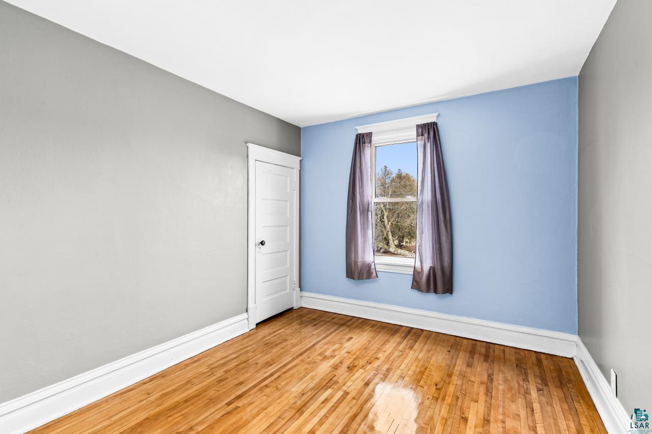 607 3rd Avenue East Superior, WI 54880 - Photo 19 of 41 Empty room with light wood-style floors and baseboards