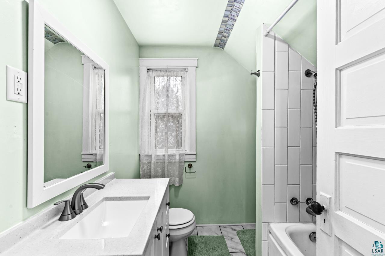 607 3rd Avenue East Superior, WI 54880 - Photo 21 of 41 Full bathroom featuring vanity, shower / bath combination, and vaulted ceiling