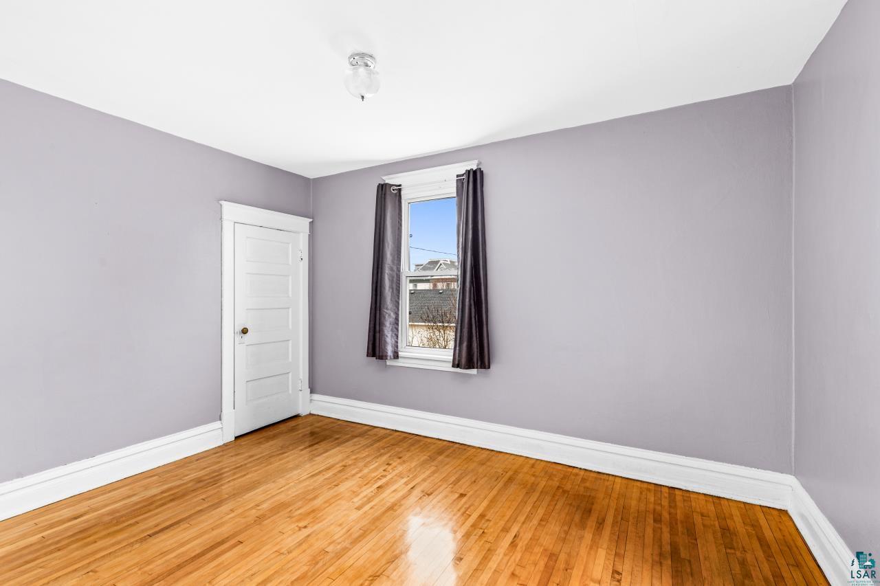607 3rd Avenue East Superior, WI 54880 - Photo 23 of 41 Spare room with baseboards and light wood-type flooring