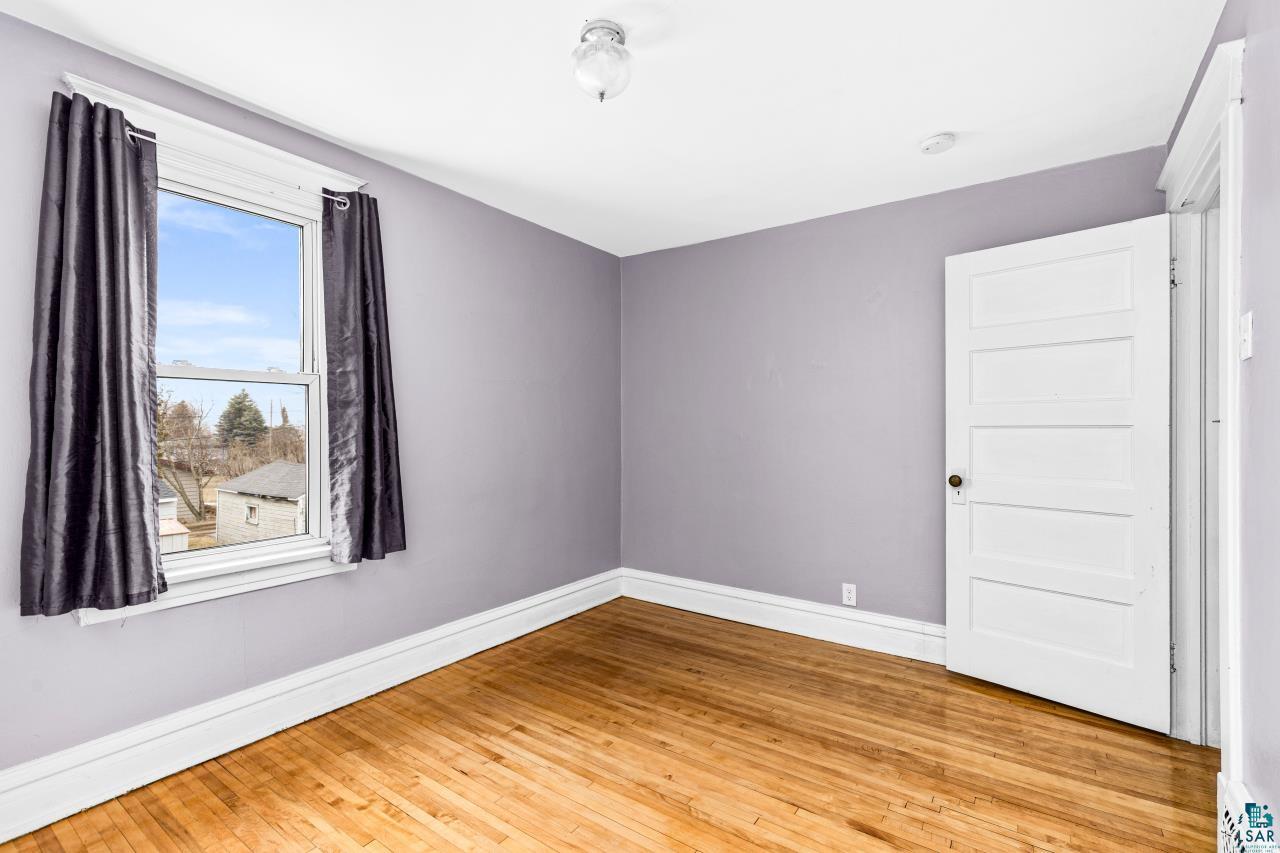 607 3rd Avenue East Superior, WI 54880 - Photo 24 of 41 Empty room featuring light wood finished floors and baseboards