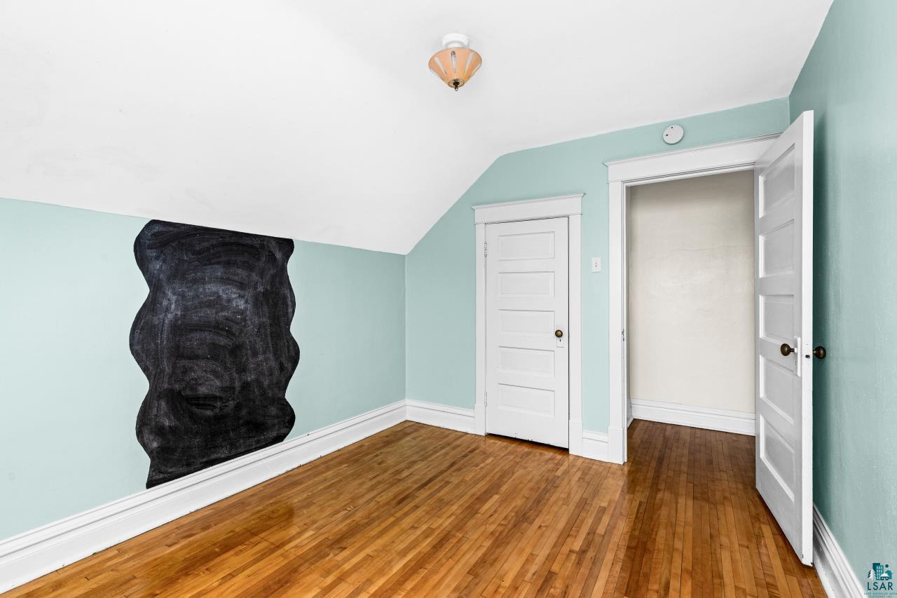 607 3rd Avenue East Superior, WI 54880 - Photo 26 of 41 Bonus room with vaulted ceiling and dark wood finished floors