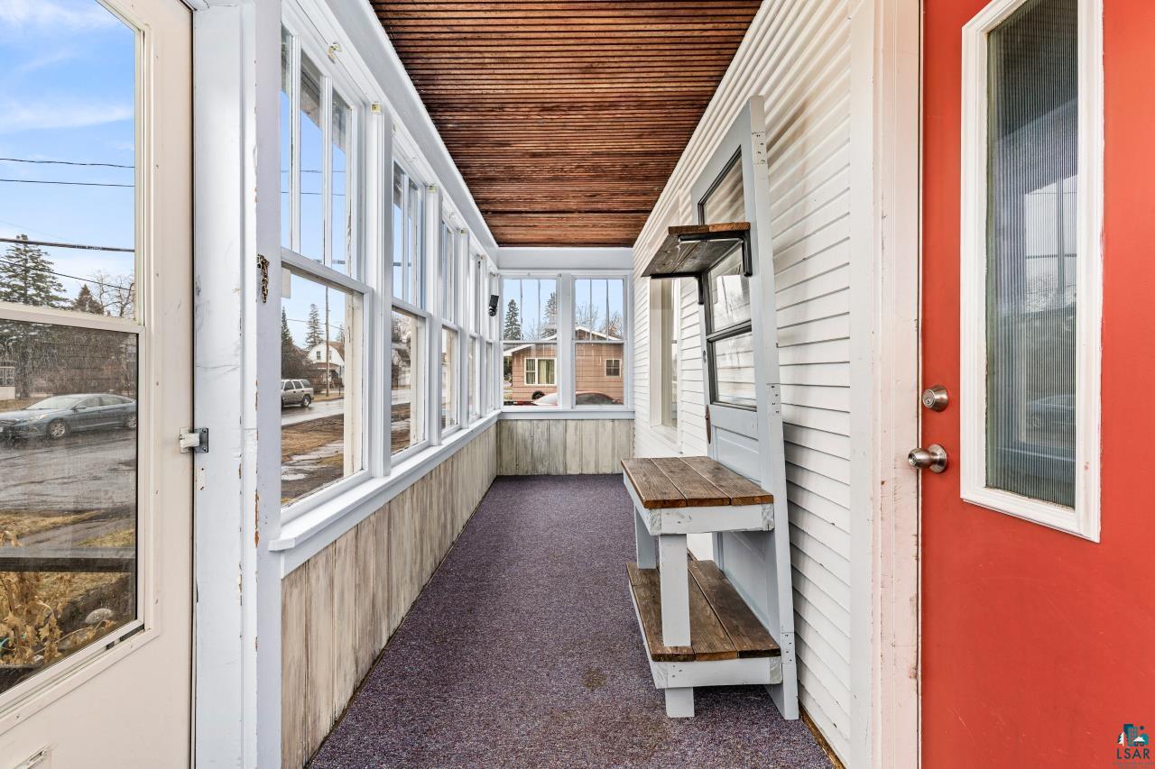607 3rd Avenue East Superior, WI 54880 - Photo 30 of 41 Unfurnished sunroom featuring wood ceiling, carpet flooring, and wooden walls