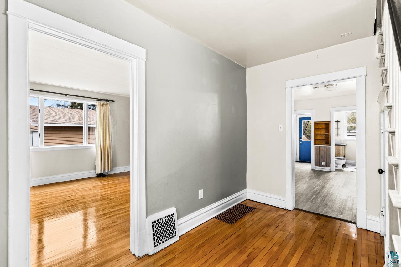 607 3rd Avenue East Superior, WI 54880 - Photo 6 of 41 Unfurnished room featuring light wood-style flooring and baseboards