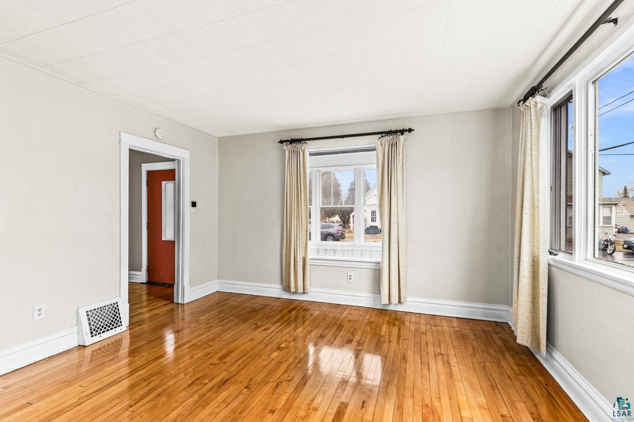 607 3rd Avenue East Superior, WI 54880 - Photo 7 of 41 Empty room with light wood-style floors and baseboards