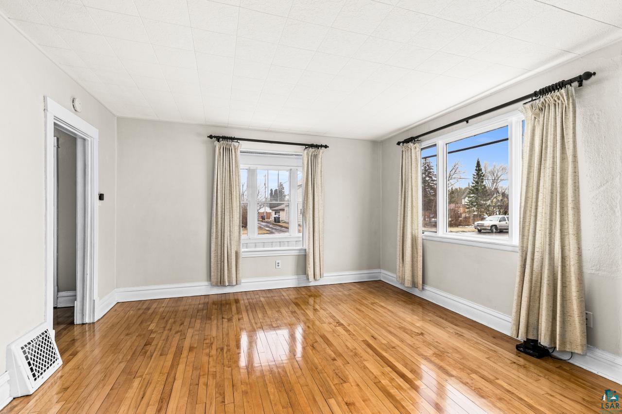 607 3rd Avenue East Superior, WI 54880 - Photo 8 of 41 Spare room with light wood-type flooring and plenty of natural light