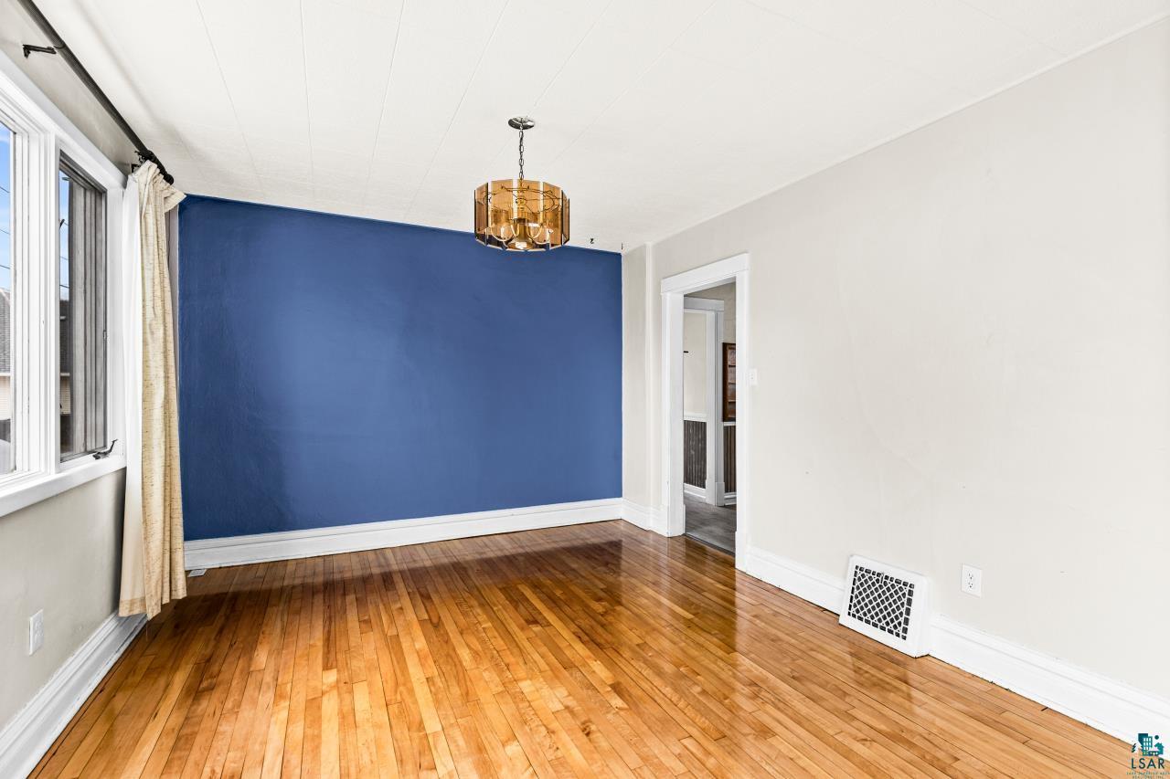 607 3rd Avenue East Superior, WI 54880 - Photo 10 of 41 Unfurnished room with light wood-style flooring and baseboards