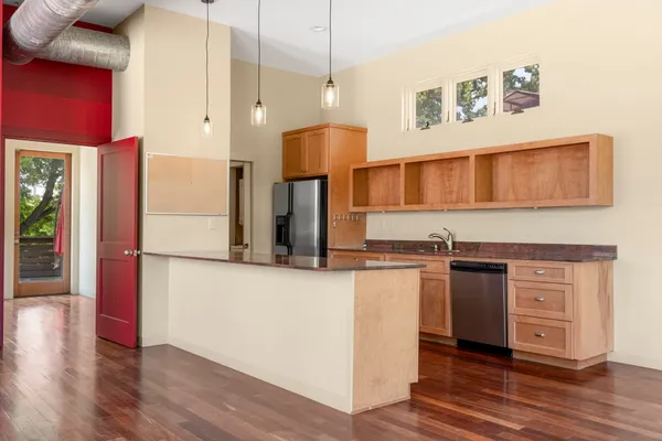 a kitchen with stainless steel appliances granite countertop a stove and a refrigerator