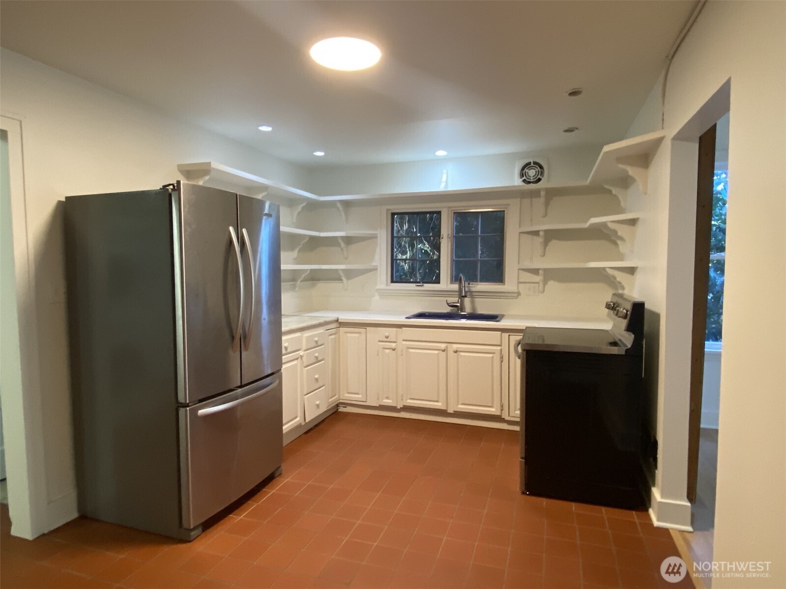 2611 3rd Avenue West Seattle, WA 98119 - Photo 12 of 13 a kitchen with a refrigerator and a sink