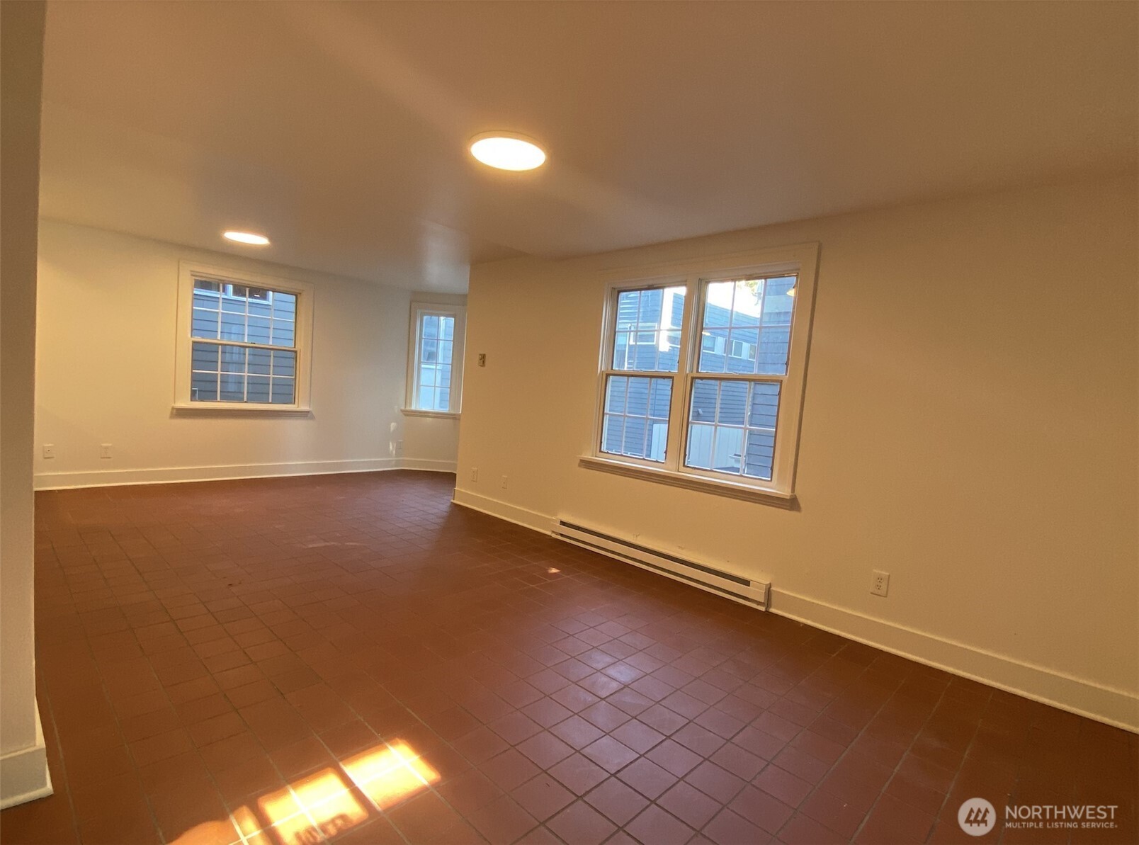 2611 3rd Avenue West Seattle, WA 98119 - Photo 2 of 13 an empty room with wooden floor and windows