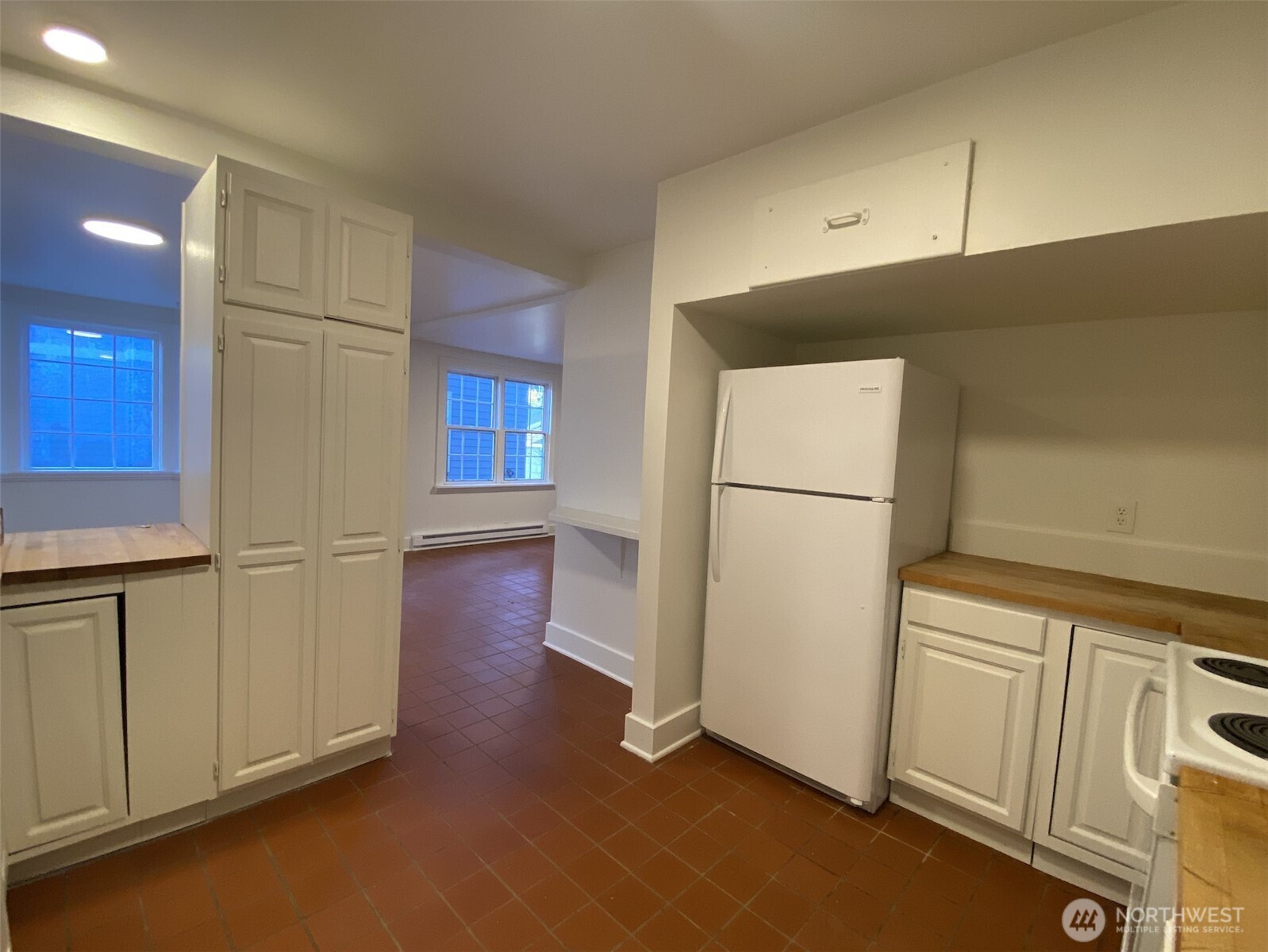 2611 3rd Avenue West Seattle, WA 98119 - Photo 5 of 13 a view of a refrigerator in kitchen and an empty room
