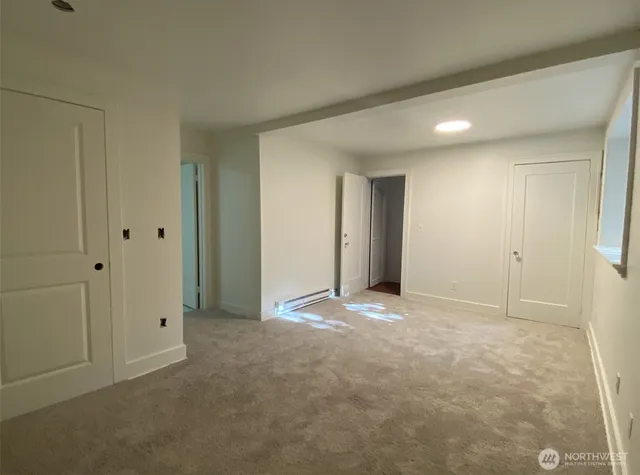 a view of an empty room and closet area