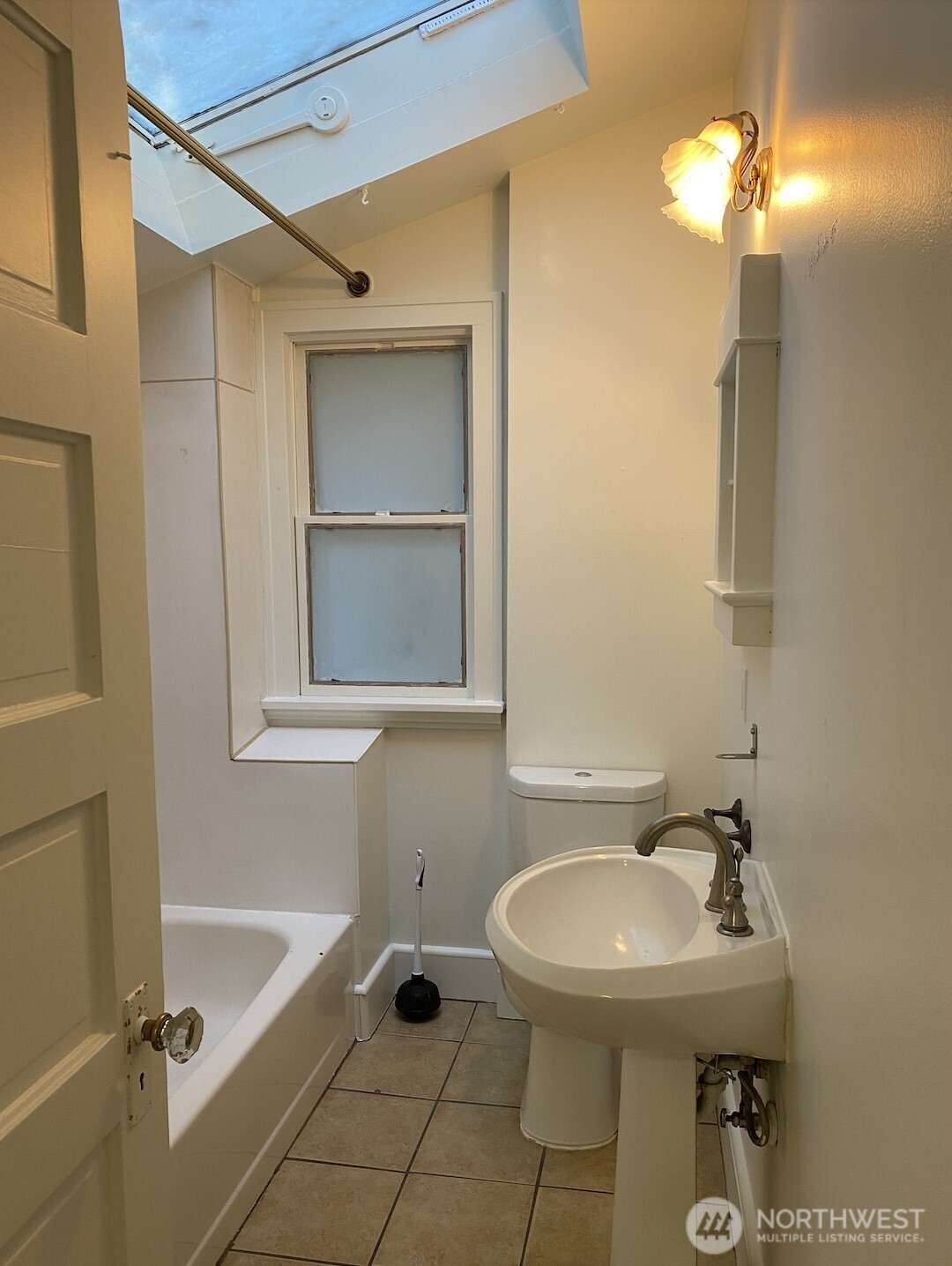 2611 3rd Avenue West Seattle, WA 98119 - Photo 8 of 13 a bathroom with a sink and a mirror
