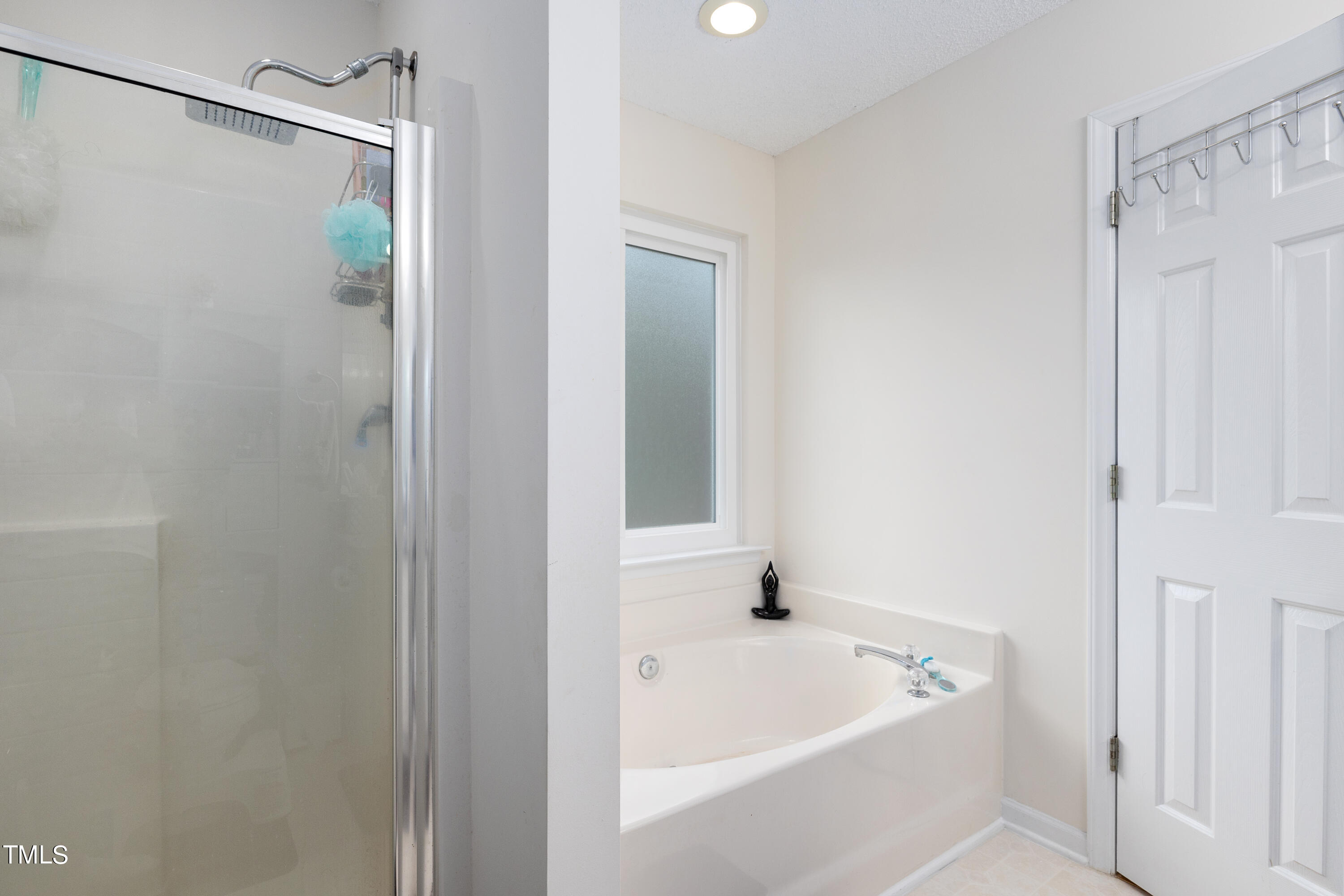 3 Weeping Beech Way Durham, NC 27713 - Photo 14 of 26 a white bath tub with a shower and a sink
