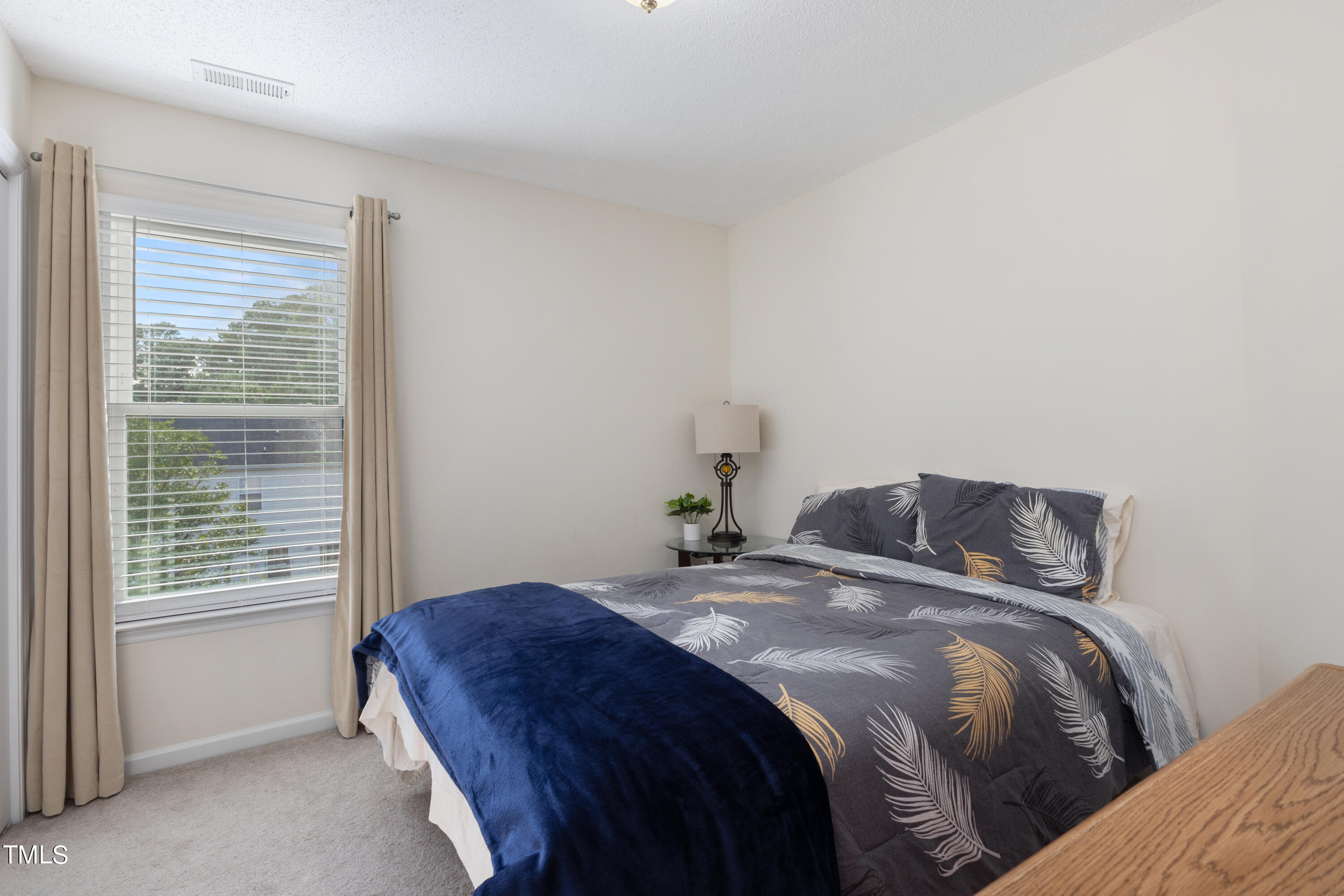 3 Weeping Beech Way Durham, NC 27713 - Photo 16 of 26 a bedroom with a bed and a window
