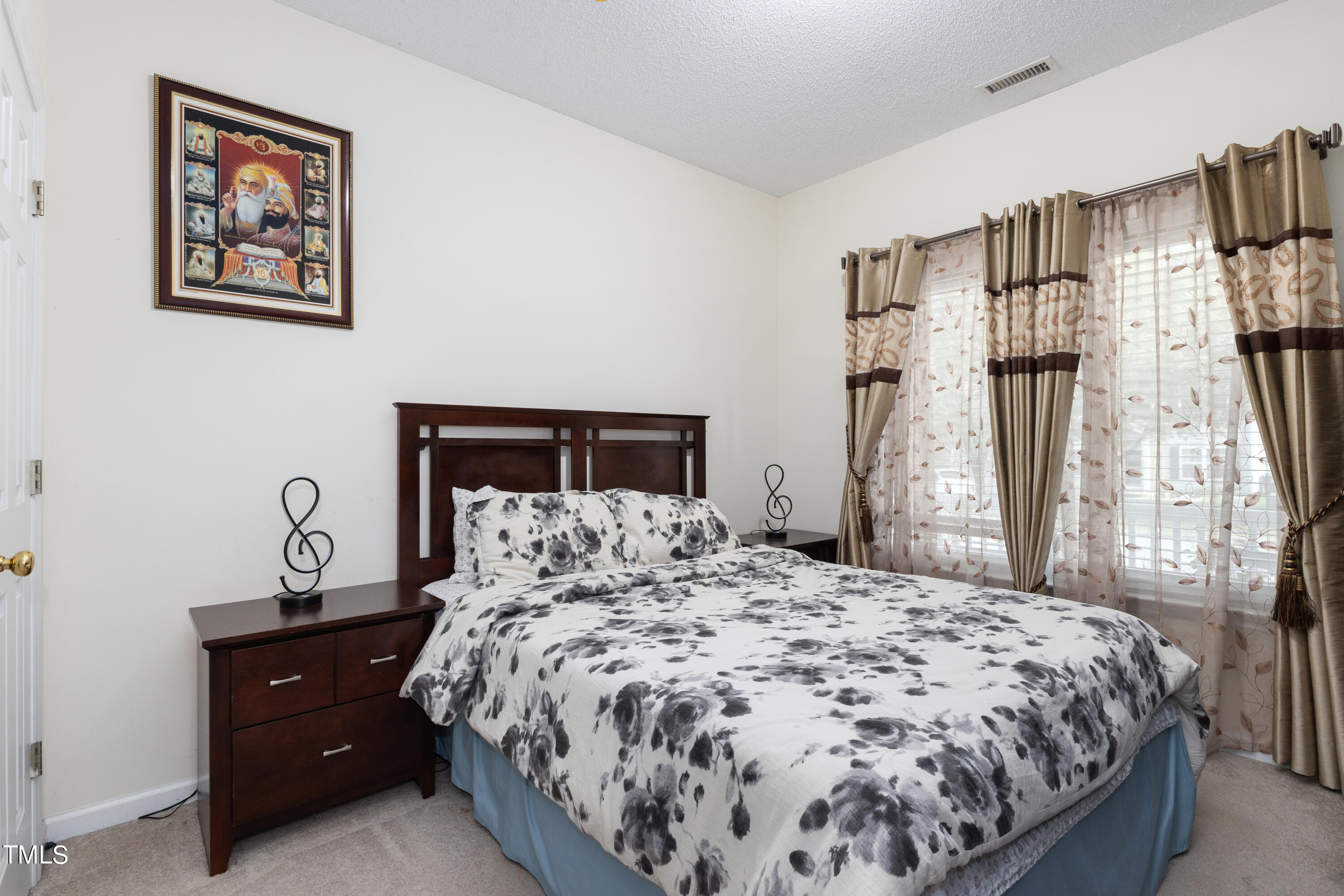 3 Weeping Beech Way Durham, NC 27713 - Photo 17 of 26 a bedroom with a bed and a dresser