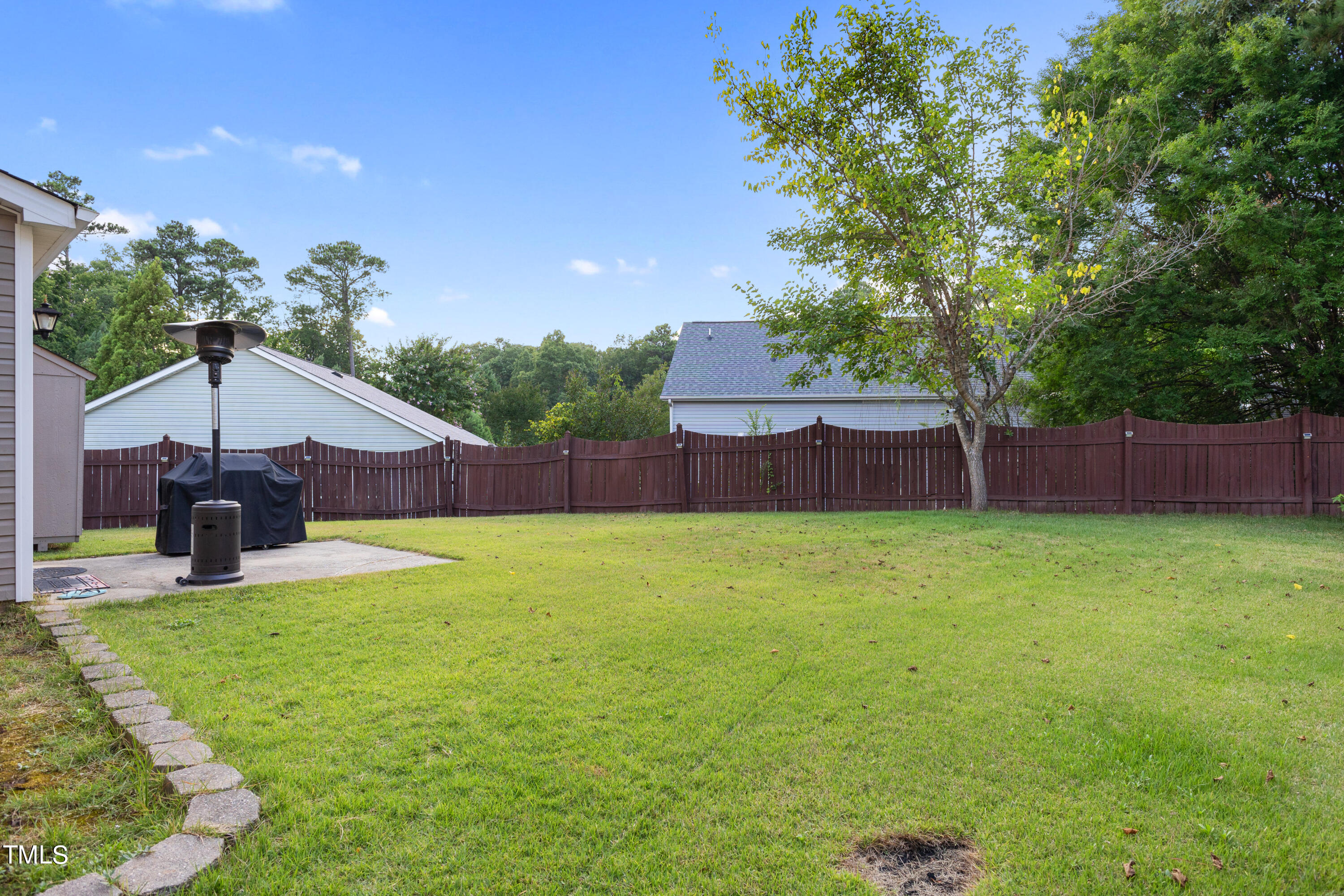 3 Weeping Beech Way Durham, NC 27713 - Photo 22 of 26 a backyard of a house with table and chairs