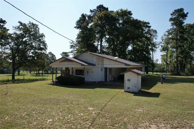 a front view of a house with a garden and plants