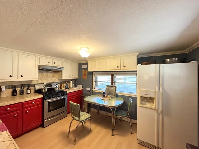 a kitchen with a sink stove and cabinets