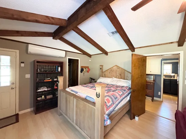 a bedroom with bed and balcony