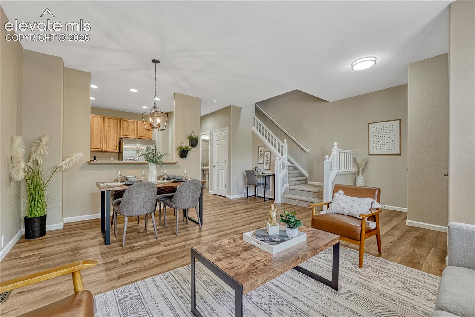 4147 Diamond Ridge View Colorado Springs, CO 80918 - Photo 7 of 42 An elegant, inviting view from the main living room showcases the seamless flow and light-filled entry of this beautifully maintained home