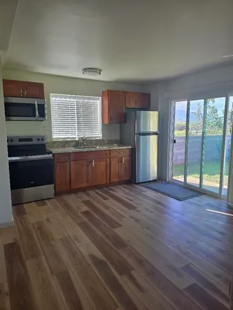 a large kitchen with stainless steel appliances granite countertop a stove and a refrigerator