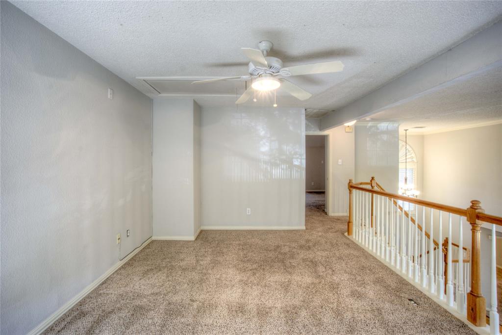 14584 Whitman Court Addison, TX 75001 - Photo 19 of 24 Spare room with a textured ceiling, carpet, a ceiling fan, and a chandelier