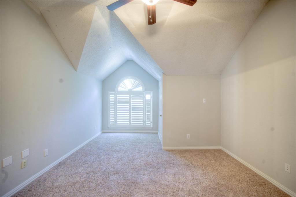 14584 Whitman Court Addison, TX 75001 - Photo 20 of 24 Additional living space with vaulted ceiling, carpet flooring, a textured ceiling, and ceiling fan
