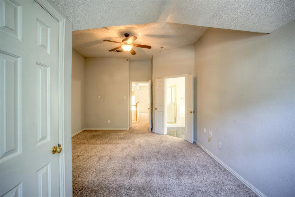 14584 Whitman Court Addison, TX 75001 - Photo 21 of 24 Spare room featuring carpet flooring, a textured ceiling, and ceiling fan