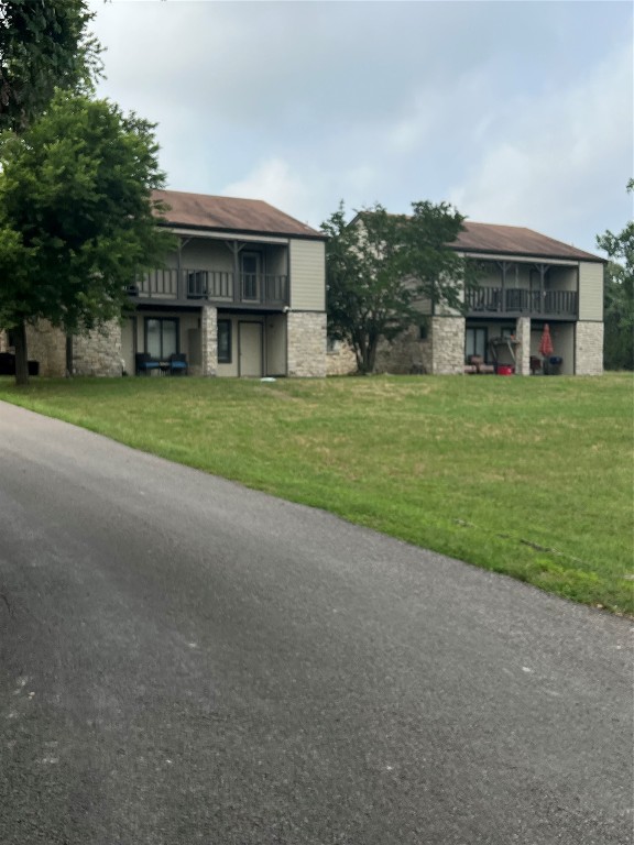 a view of a big house with a big yard and large trees