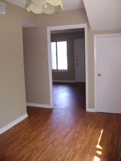 151-201 Springlake Drive Dripping Springs, TX 78620 - Photo 12 of 12 a view of a room with wooden floor and window